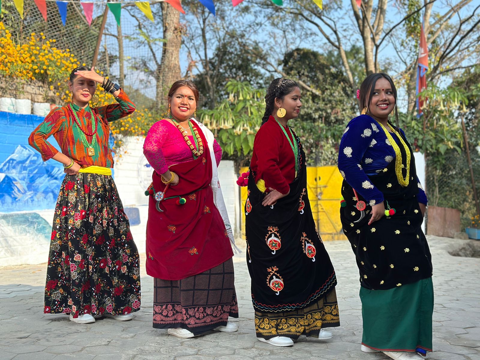 Some of the Nepal orphan girls who are getting older dancing in full dress.